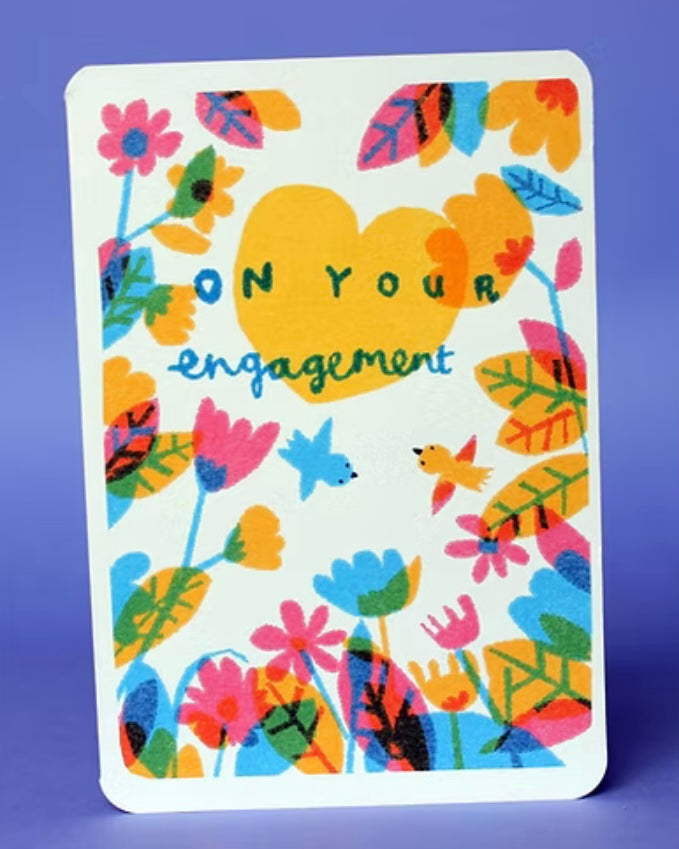 Colourful card with floral patterns and 'On Your Engagement' text. Card is on a purple background.