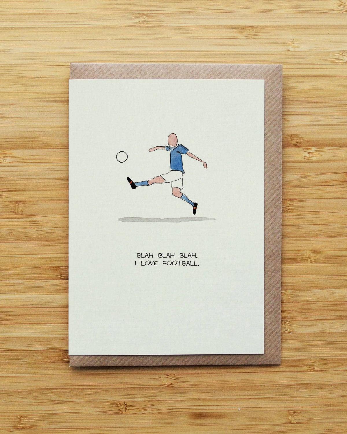 A rectangular greeting card with a brown envelope, featuring a hand-drawn illustration of a soccer player kicking a ball with the text 'BLAH BLAH BLAH. I LOVE FOOTBALL.