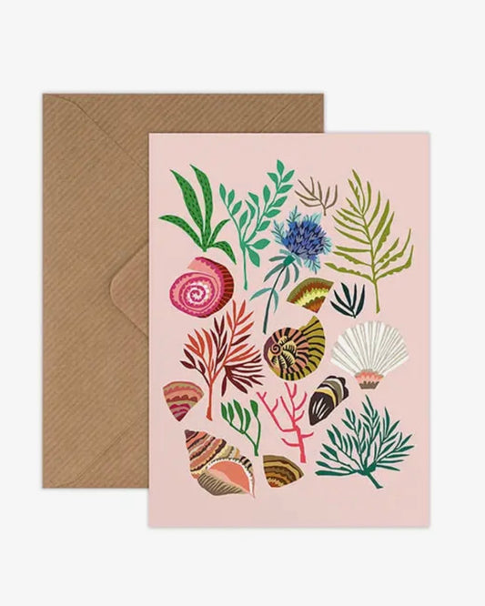 Card with floral and shell design on a pink background with brown envelope