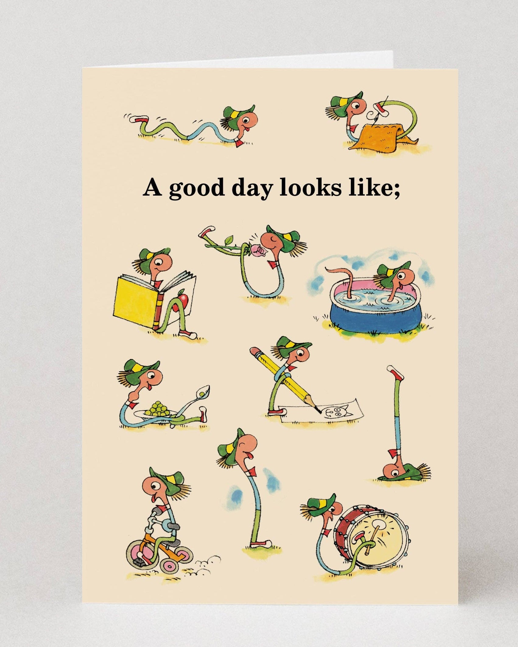 Card with Richard Scarry illustrations of a character doing various activities and text 'A good day looks like:' on a beige background.