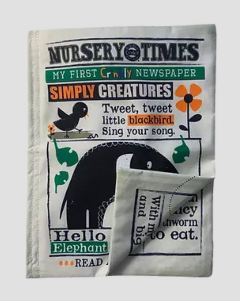Children's soft crinkly book titled 'Nursery Times' with a black and white design on a white background